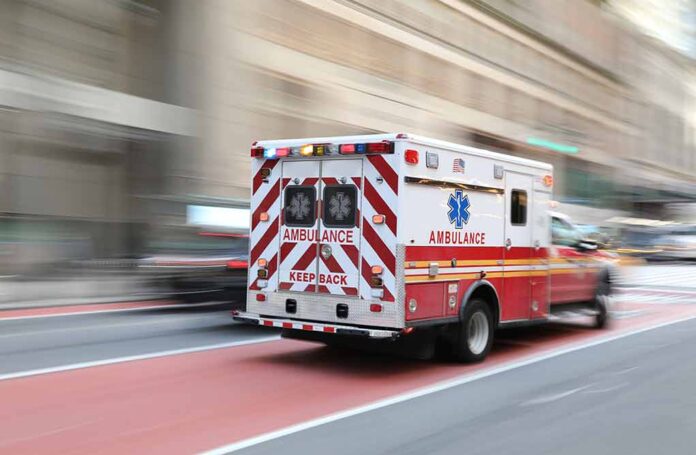 Ambulance driving quickly on a city street.