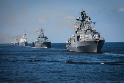 Several naval warships sailing in the ocean.