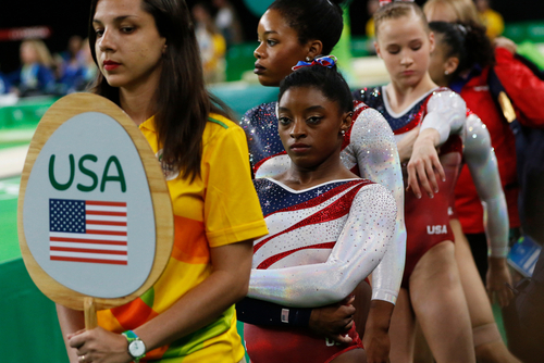 USA gymnasts waiting in line at an event.