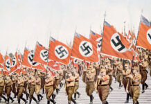 Nazi soldiers marching with swastika flags, World War II.