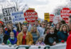 Protesters holding anti-abortion signs at a rally.