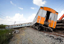 Derailed train leaning off the track.