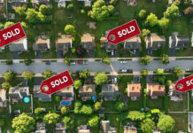 Aerial view of neighborhood with Sold signs on houses.