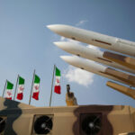 Military missiles displayed with Iranian flags in the background