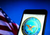Peace Gambit: Trump Dials Both Sides Department of Defense logo on a smartphone screen.
