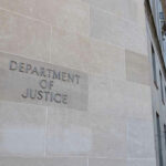 Department of Justice building with American flags outside.