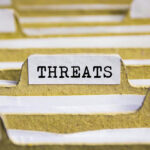 Pentagon HAZMAT Scare Triggers Lockdown — What’s REALLY Going ON? File tab labeled THREATS in a folder.