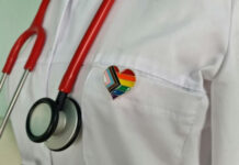 YOUTH GENDER CARE Advocate NOW TOP of SOCIETY for Pediatrics?? Doctors coat with stethoscope and rainbow heart badge.