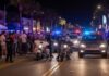 Title Night Turns Into CHAOTIC City MELTDOWN Police officers managing a crowd on a busy street at night