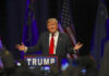 The Future Of Trump’s Iran Framework May Depend On What Happens Next A speaker gesturing passionately at a political rally with American flags in the background