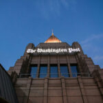 The Washington Post building against a twilight sky.