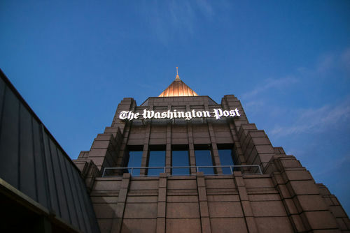 The Washington Post building against a twilight sky.