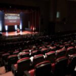 Audience in a theater watching a stage presentation